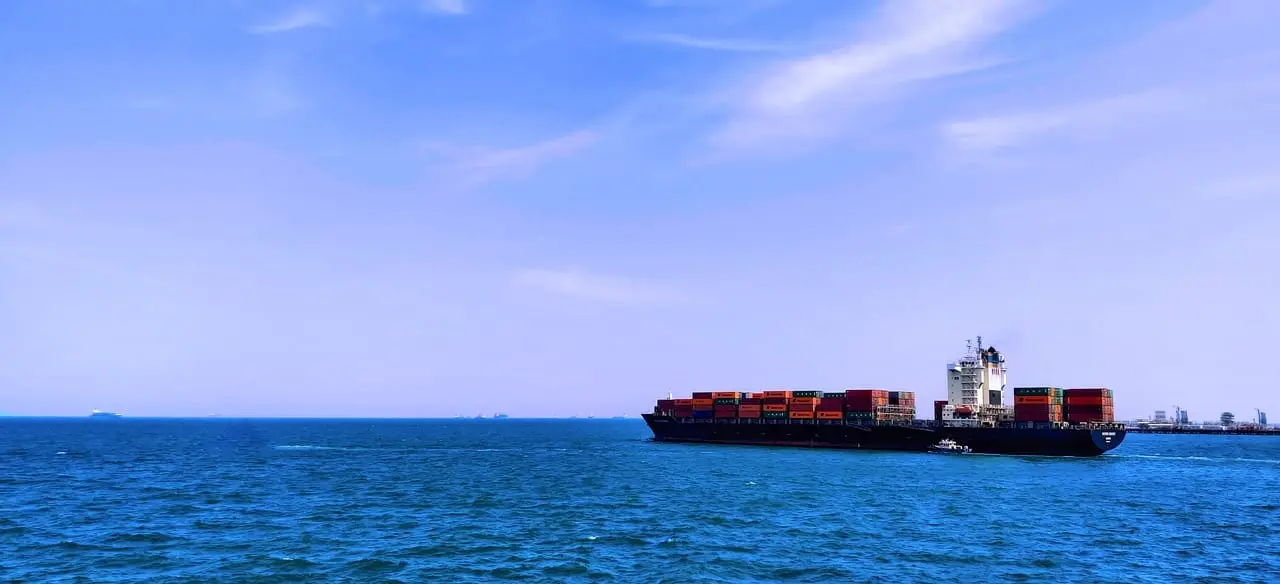Container ship sailing on a calm blue sea