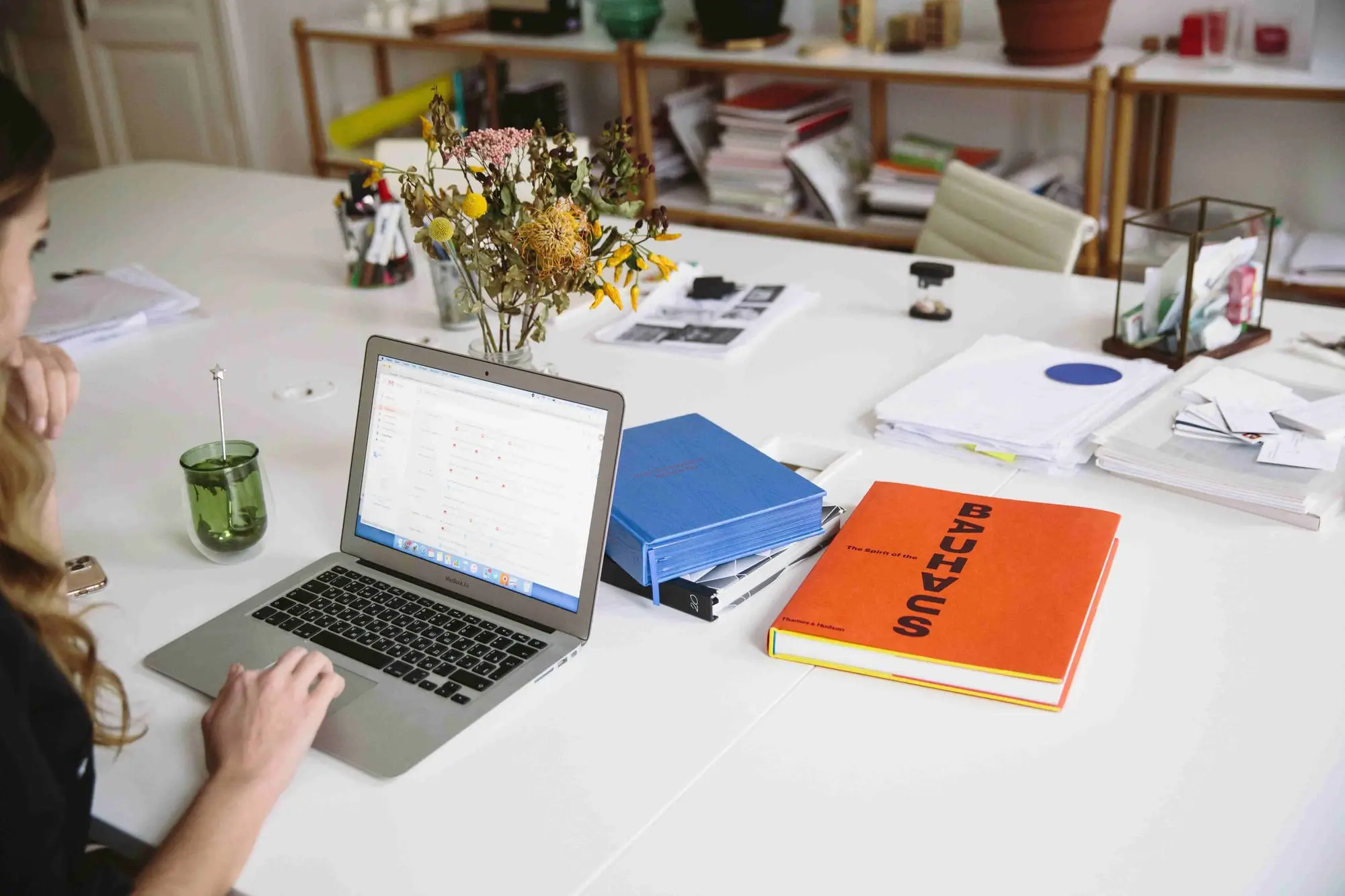 Desk with laptop, folders and export documents