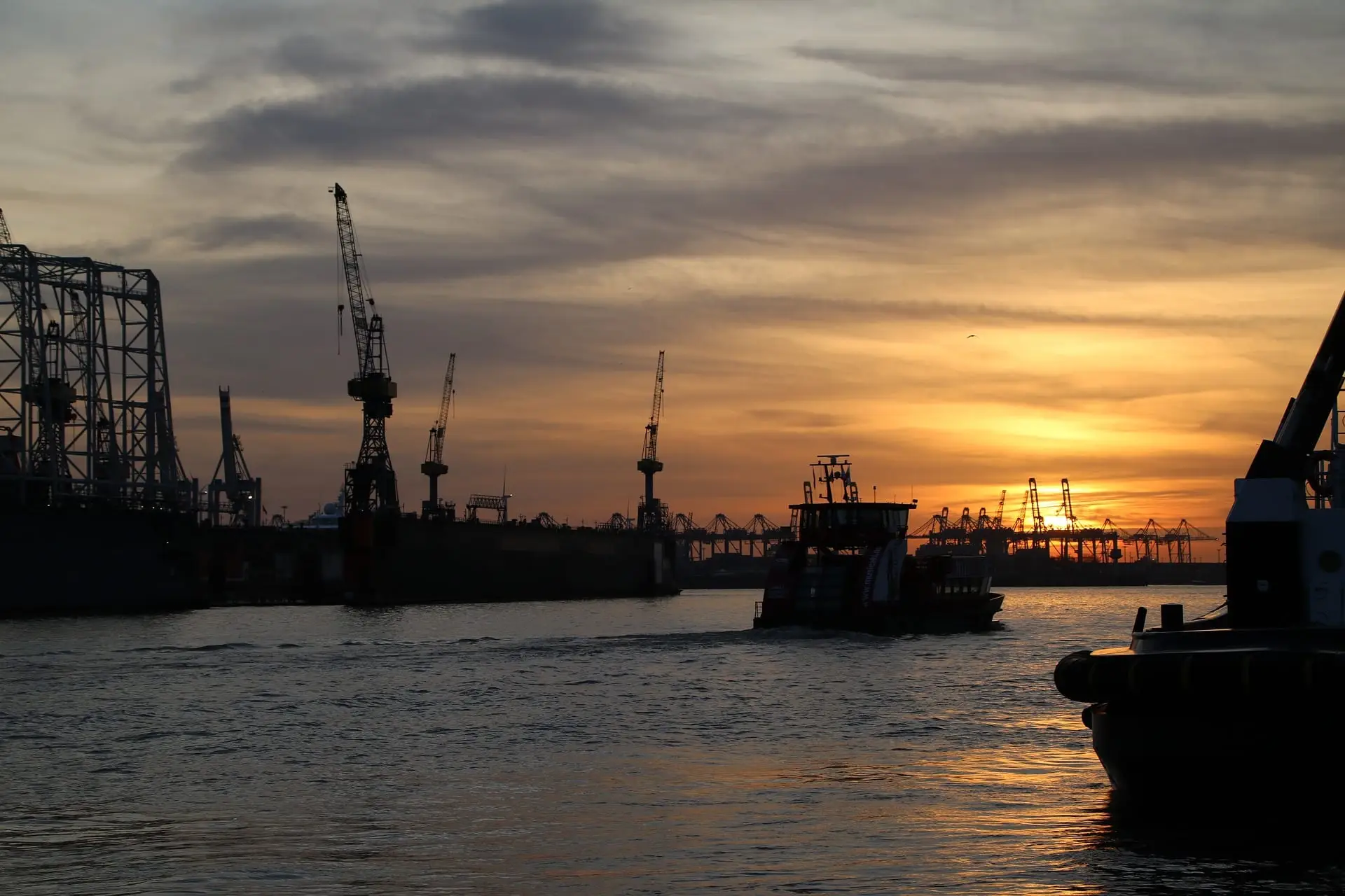 Cargo port with cranes at sunset