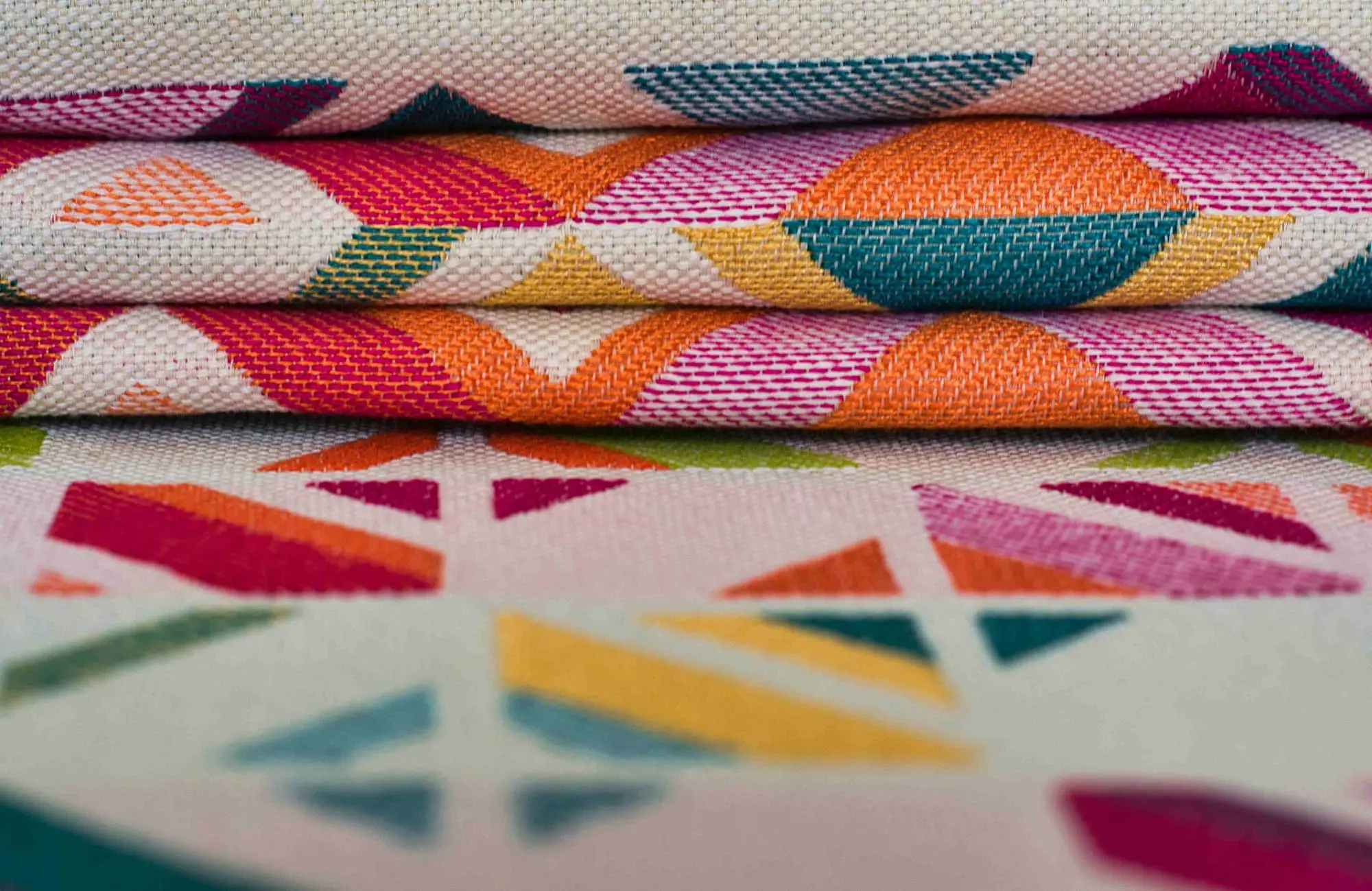 Stack of colourful patterned textile fabrics